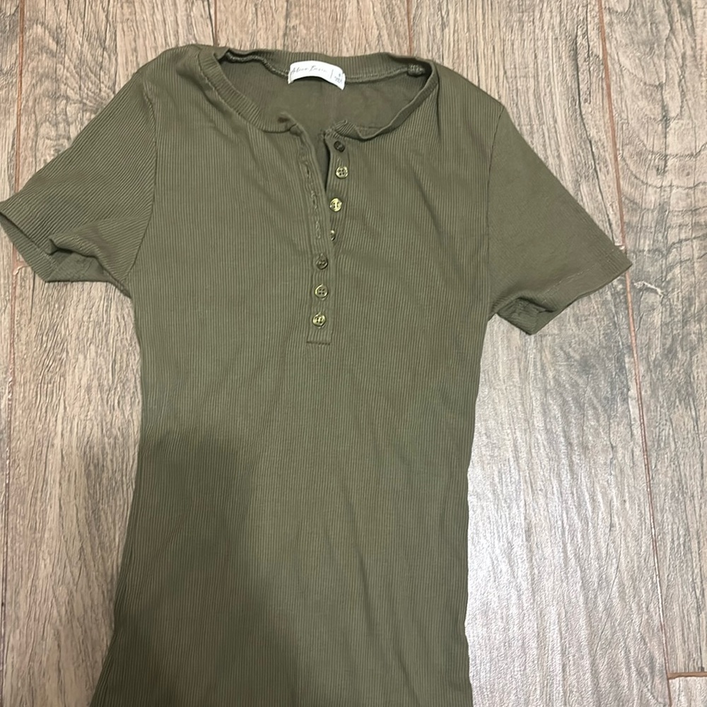 This is a green button up women’s tee shirt